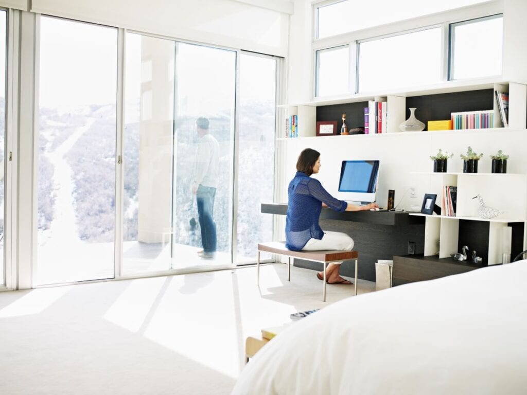 Woman working at floating desk in bedroom