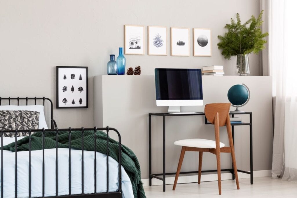 Bedroom with workspace and small wall art